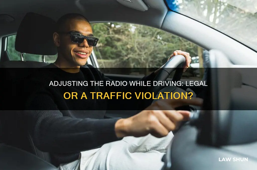is it against the law to adjust radio while driving